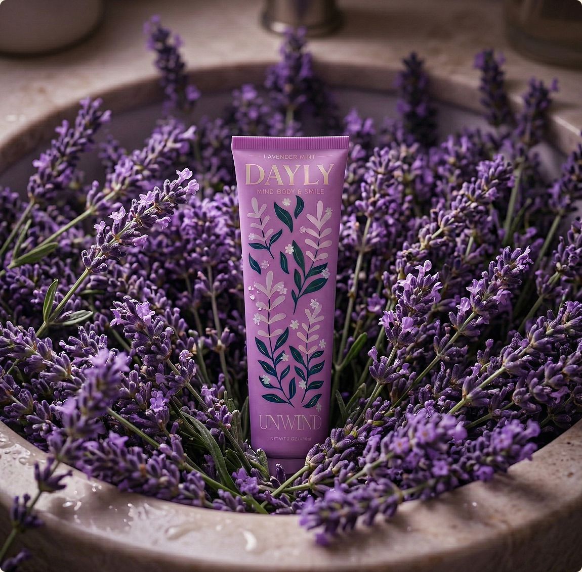 DAYLY UNWIND lavender mint toothpaste resting in a bowl of fresh lavender
