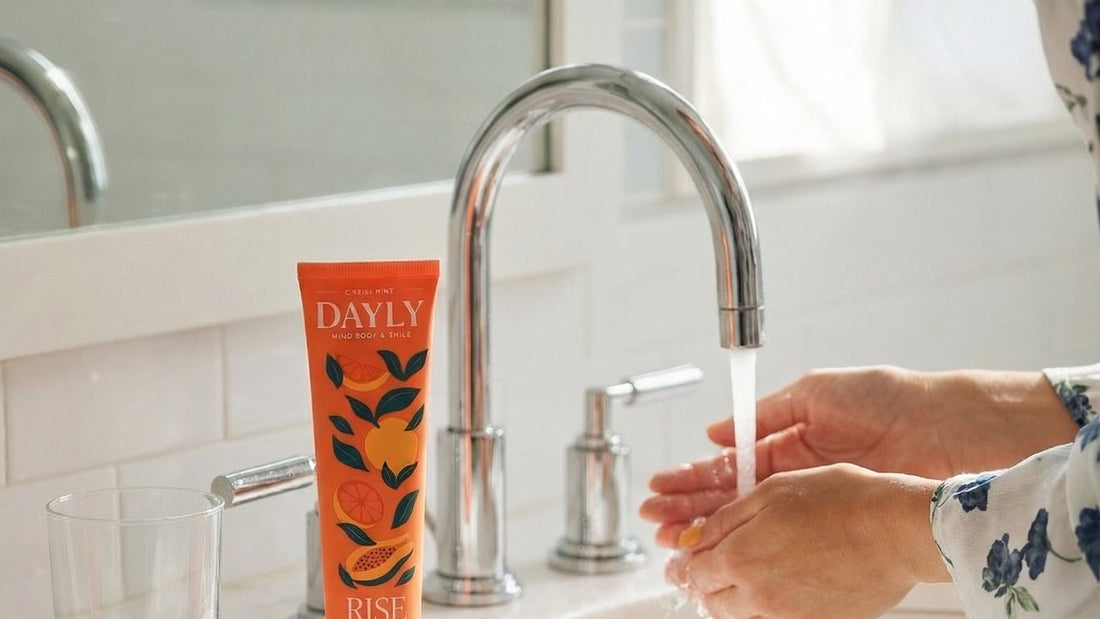 DAYLY Rise toothpaste on a bathroom sink with running water